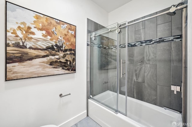 bathroom with baseboards and shower / bath combination with glass door