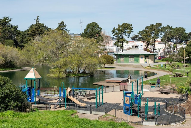 dock area with playground community and a water view