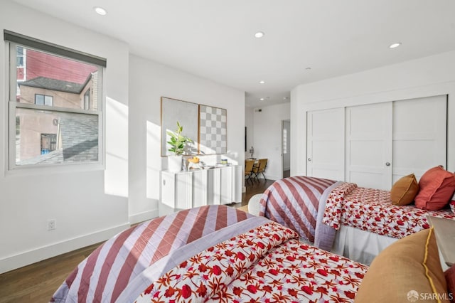 bedroom featuring recessed lighting, a closet, baseboards, and wood finished floors