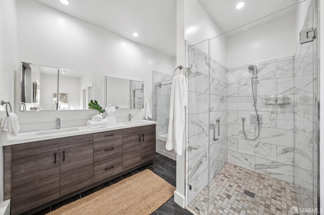 full bathroom featuring double vanity, recessed lighting, a stall shower, and a sink