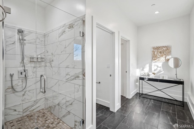 full bath with baseboards, a stall shower, and vanity