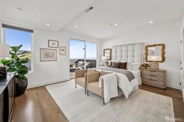 bedroom with visible vents, wood finished floors, recessed lighting, baseboards, and access to exterior