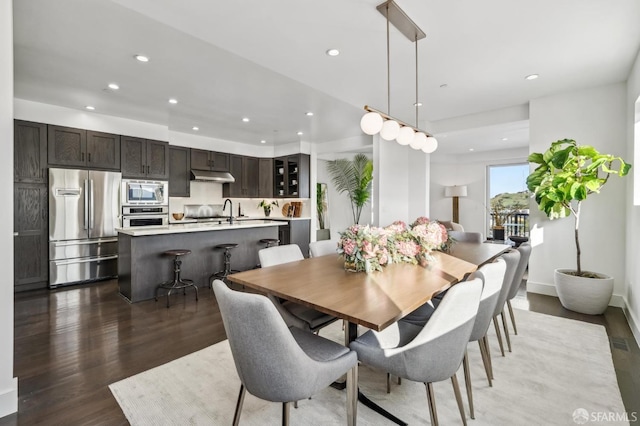 dining space with dark wood-type flooring, recessed lighting, baseboards, and visible vents