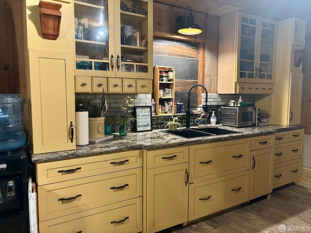 490 Huckleberry Ln, Boulder Creek, CA 95006 - kitchen featuring decorative backsplash, dark wood-type flooring, glass insert cabinets, cream cabinets, and dark stone counters