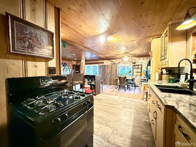 490 Huckleberry Ln, Boulder Creek, CA 95006 - kitchen with black range with gas stovetop, wood ceiling, wood walls, light stone countertops, and light wood-style floors