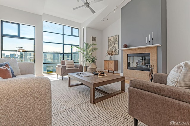 236 Clara St Unit 6, San Francisco, CA 94107 - living area featuring ceiling fan, a glass covered fireplace, high vaulted ceiling, and light carpet