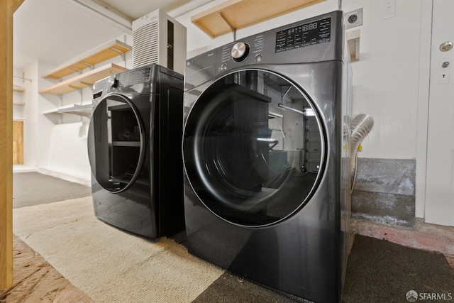 laundry room featuring washing machine and clothes dryer and laundry area