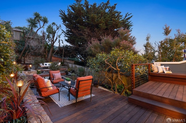 deck with outdoor lounge area and fence