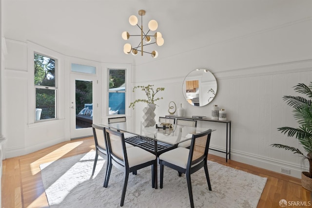 dining area featuring wood finished floors and a chandelier