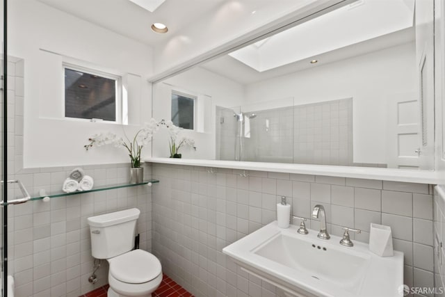 full bath with recessed lighting, a sink, a shower stall, tile walls, and toilet