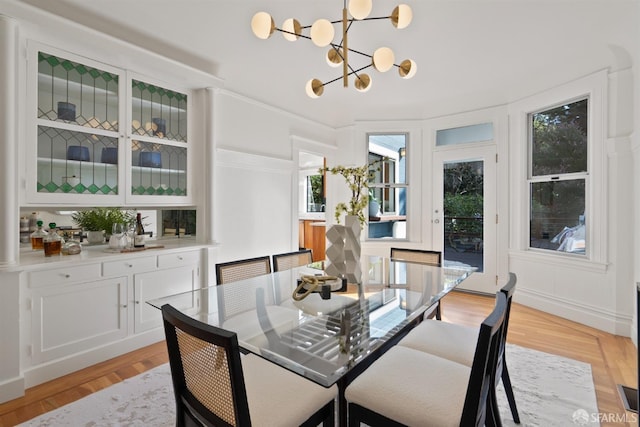 dining room featuring light wood-style flooring and a notable chandelier