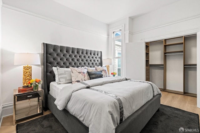 bedroom featuring a closet and wood finished floors