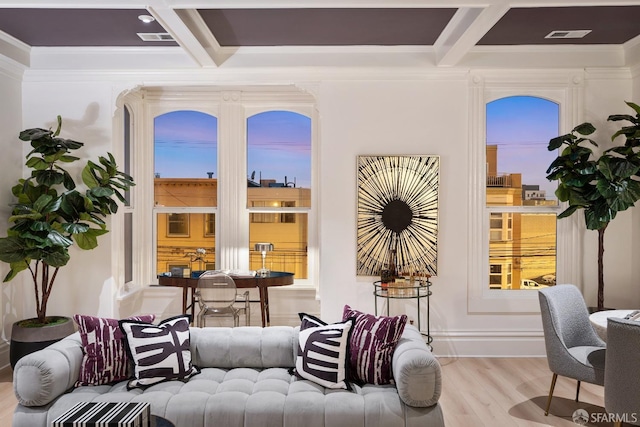 living area with crown molding, coffered ceiling, light hardwood / wood-style flooring, and beamed ceiling