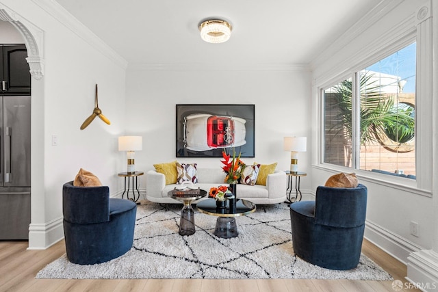 living room featuring hardwood / wood-style flooring and ornamental molding