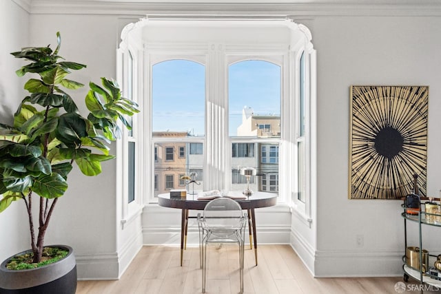 dining area with baseboards and light wood-type flooring