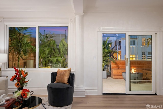 entryway with decorative columns, french doors, and light hardwood / wood-style flooring