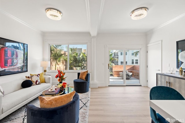 living area featuring light wood-style flooring, a wealth of natural light, and ornamental molding