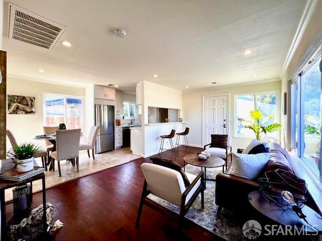 590 Hurlingame Ave, Redwood City, CA 94063 - dining room featuring healthy amount of natural light, wood finished floors, crown molding, and recessed lighting