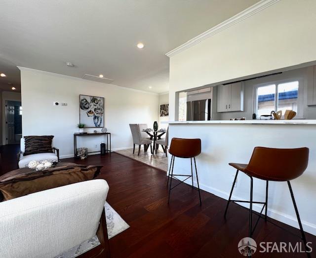 590 Hurlingame Ave, Redwood City, CA 94063 - kitchen with fridge, a kitchen bar, crown molding, light countertops, and baseboards