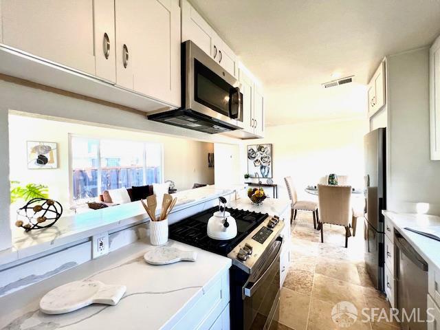 590 Hurlingame Ave, Redwood City, CA 94063 - kitchen with stainless steel appliances and white cabinetry