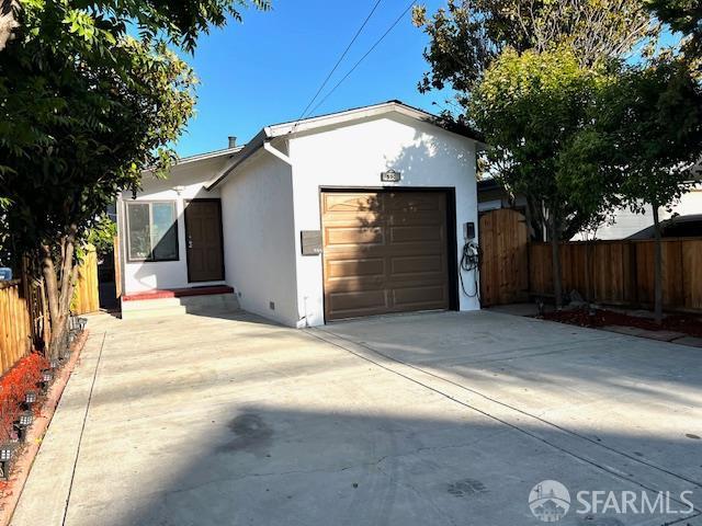 590 Hurlingame Ave, Redwood City, CA 94063 - view of front of property with an attached garage, stucco siding, and concrete driveway