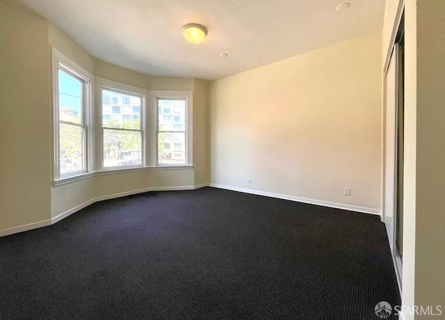 carpeted spare room with a healthy amount of sunlight