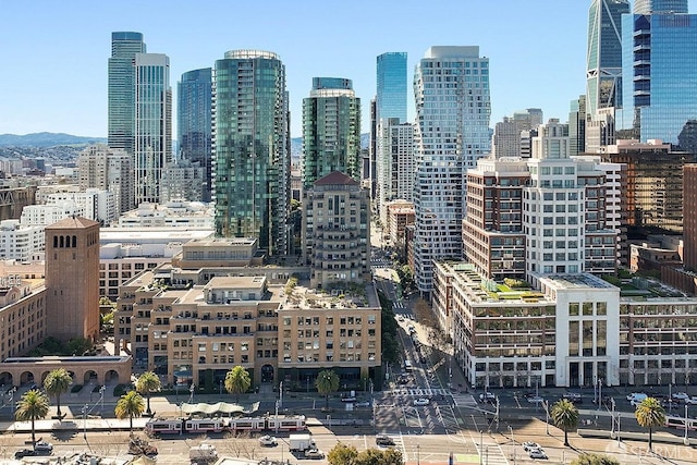 property's view of city featuring a mountain view