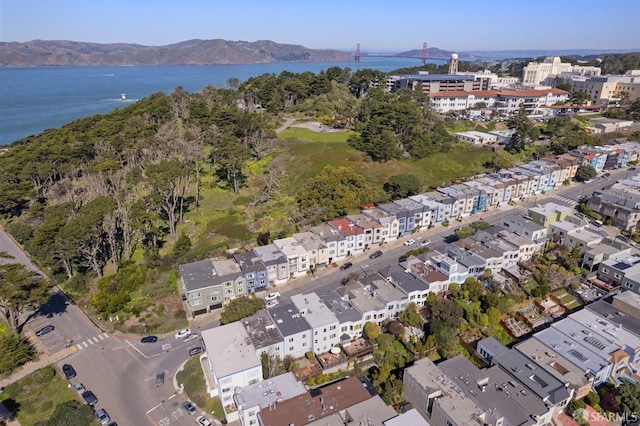 drone / aerial view featuring a water and mountain view