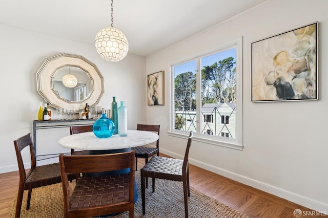 dining space with wood finished floors and baseboards