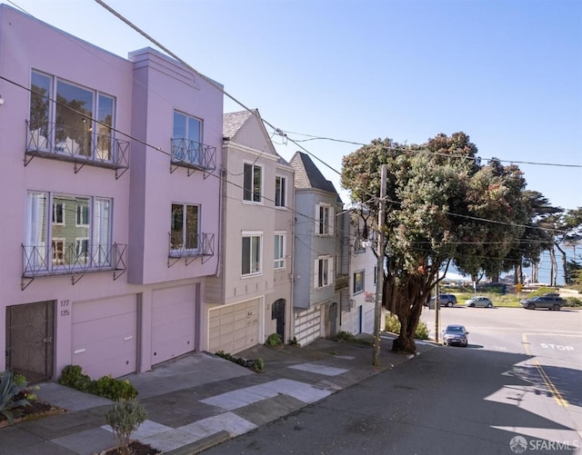 view of property featuring a garage and stucco siding