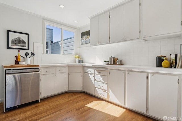 kitchen featuring recessed lighting, light countertops, backsplash, light wood-style flooring, and dishwasher