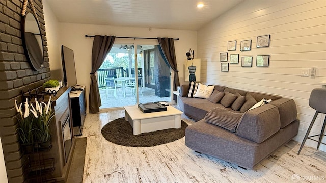 living area with light wood finished floors and vaulted ceiling