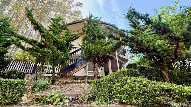 exterior space featuring stairs and stucco siding