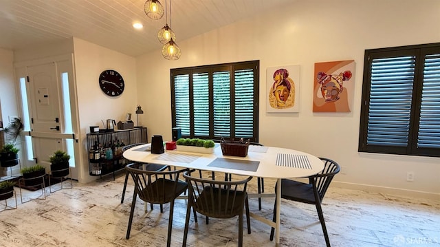 dining room featuring baseboards, wooden ceiling, and lofted ceiling