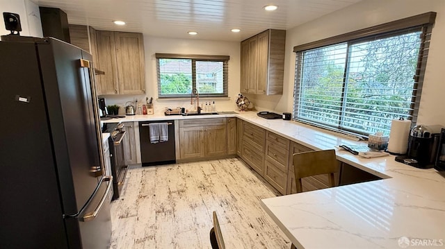 kitchen featuring light wood-style floors, black appliances, recessed lighting, light stone counters, and a sink