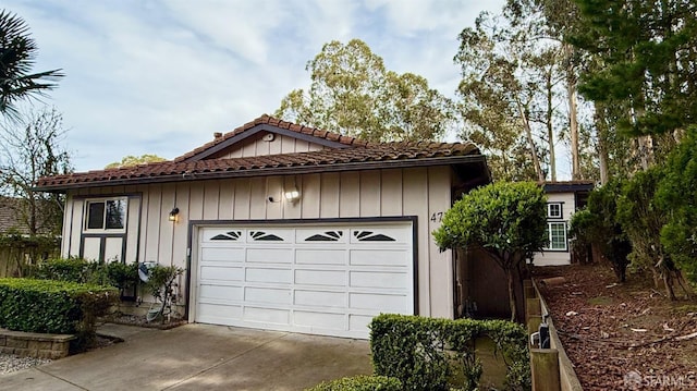 garage featuring concrete driveway