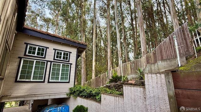 view of home's exterior with fence