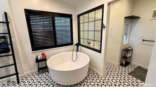 dining space featuring tile patterned floors and baseboards
