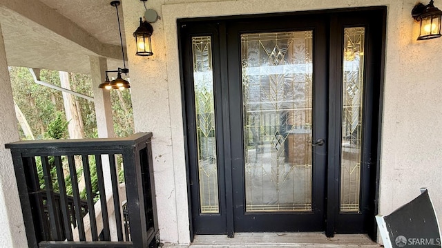 property entrance with stucco siding