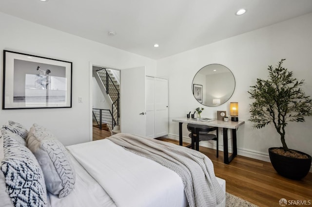 bedroom with dark hardwood / wood-style floors