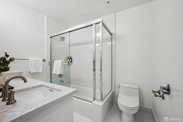 full bathroom featuring vanity, toilet, and enclosed tub / shower combo