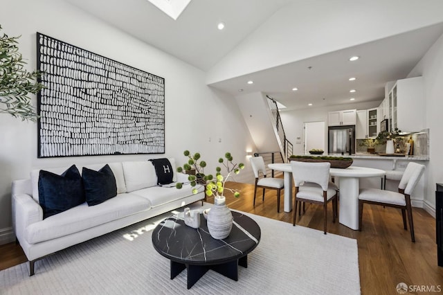 living room with high vaulted ceiling and dark hardwood / wood-style floors