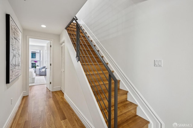 stairs featuring hardwood / wood-style flooring