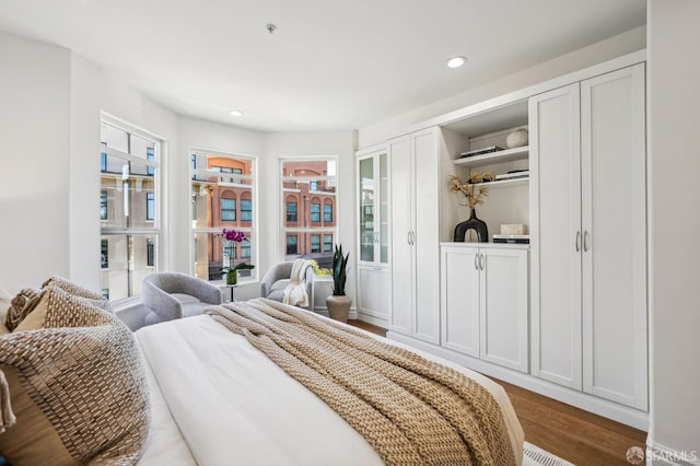 bedroom featuring dark hardwood / wood-style flooring and multiple windows