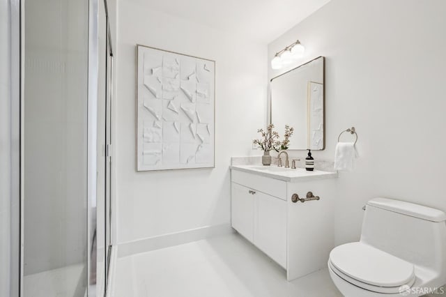 bathroom with vanity, toilet, and a shower with door