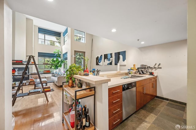 700 Illinois St Unit 3, San Francisco, CA 94107 - kitchen with stainless steel dishwasher, brown cabinetry, recessed lighting, and light countertops