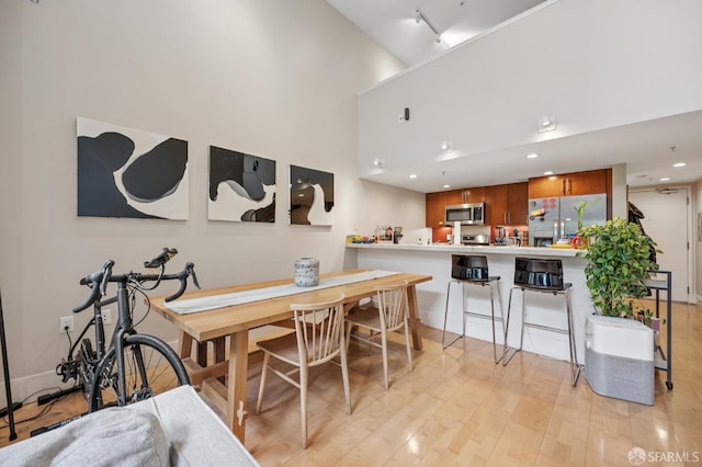 700 Illinois St Unit 3, San Francisco, CA 94107 - dining area featuring light wood finished floors, a towering ceiling, track lighting, and recessed lighting