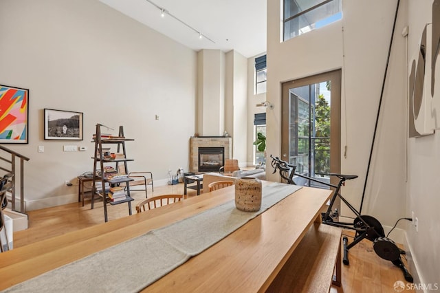 700 Illinois St Unit 3, San Francisco, CA 94107 - dining space featuring a high ceiling, wood finished floors, track lighting, and a glass covered fireplace