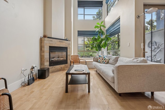 700 Illinois St Unit 3, San Francisco, CA 94107 - living room with wood finished floors, a high ceiling, and a tile fireplace