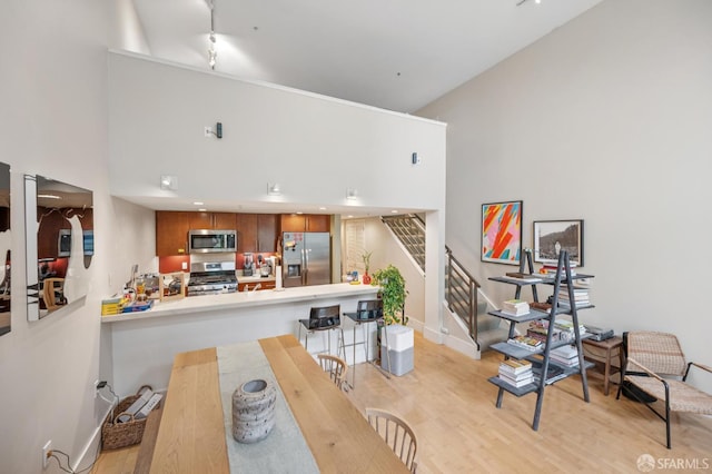 700 Illinois St Unit 3, San Francisco, CA 94107 - dining area featuring light wood-type flooring, a high ceiling, and stairway